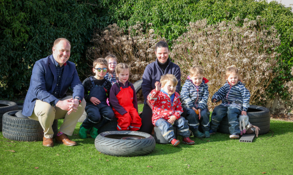 Chris Hayward (left), Development Bank of Wales and Caroline Aindow (centre) with children at Country House Childcare