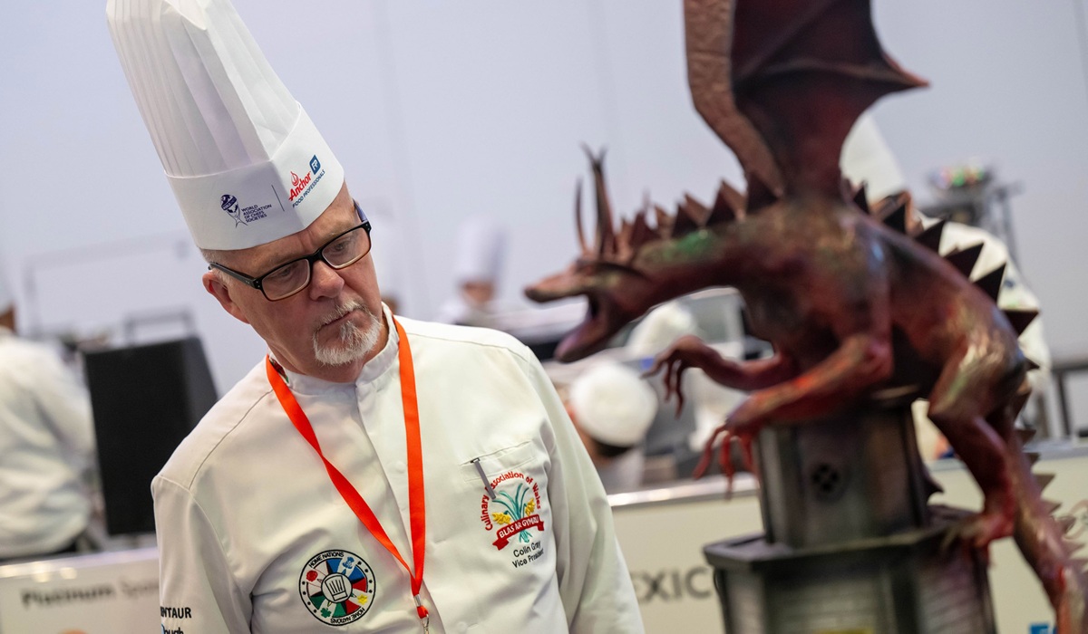 Culinary Association of Wales vice president Colin Gray admires a chocolate dragon sculpture in the Global Pastry Chef Challenge final.