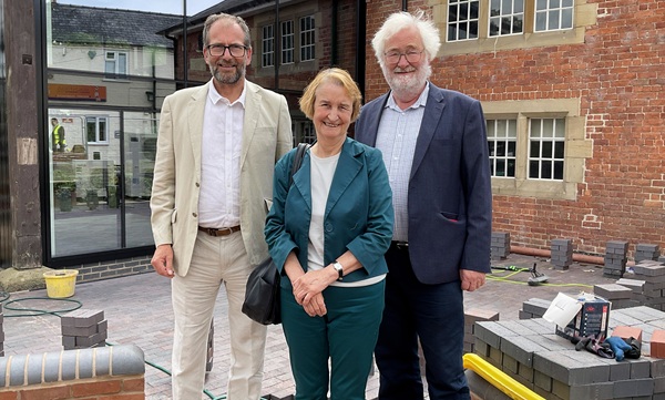 Dame Nia Griffith outside Y Lanfa in Welshpool with Powys County Council Cabinet Members, Councillor James Gibson-Watt (left) and Councillor Richard Church.