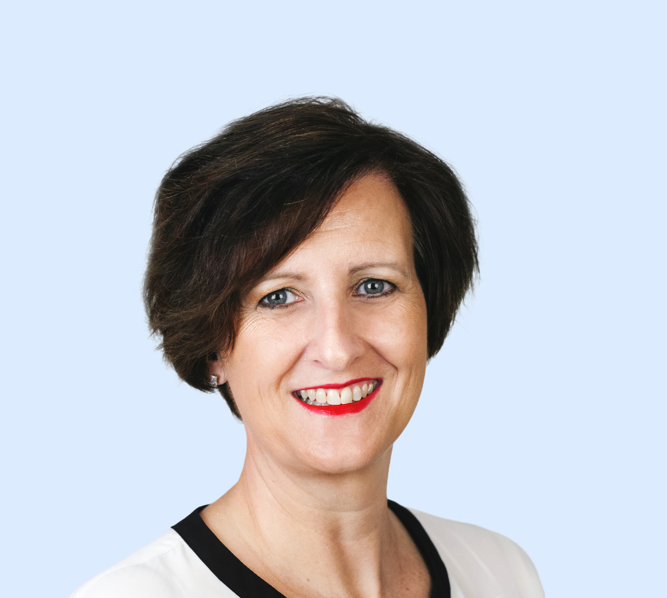 Emma-Prodromou-Headshot-Blue-Background