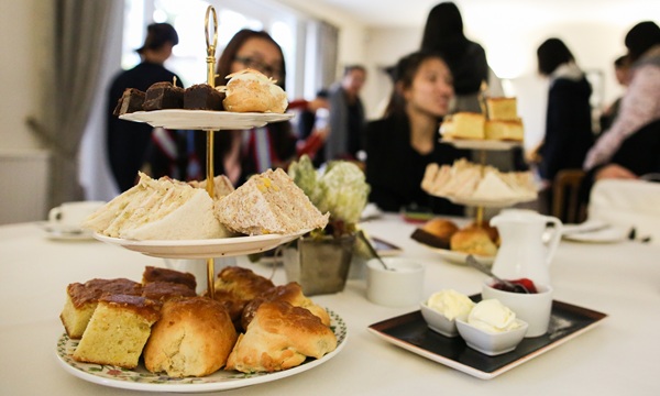 chines students visiting the conrah hotel for afternoon tea, sandwiches and cake