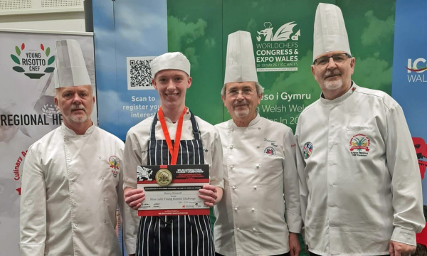 Harry Howell receives his award from Colin Gray and Arwyn Watkins, OBE from the Culinary Association of Wales and Domenico Maggi