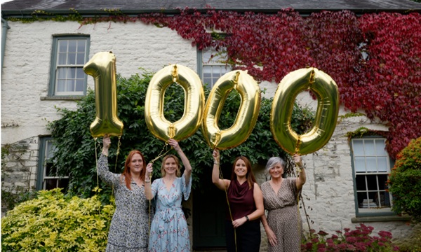 Members of the Cyfle Building Skills team celebrate passing the 1000 apprentices milestone at Llwynywermod estat