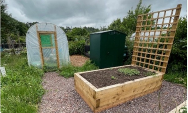 One of the new raised beds and the polytunnel that has been installed at the garden. Credit Phil Graham