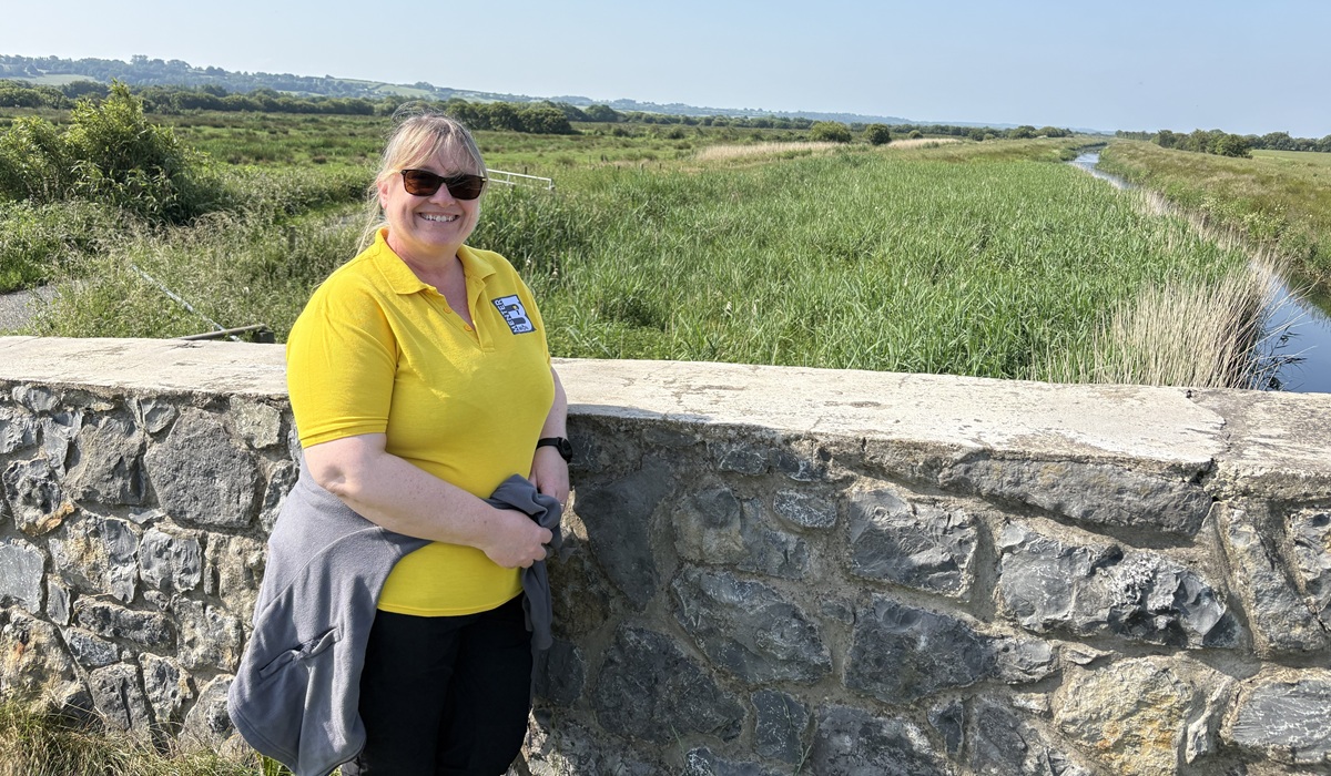 Rebecca Pritchard, Menter Môn 's Environment Manager and Glasffordd project manager standing on Lon LasMôn where the work will be carried out