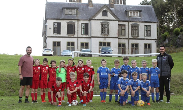 The Denbigh and Ruthin U10 sides with the historic Pool Park manor house in the background