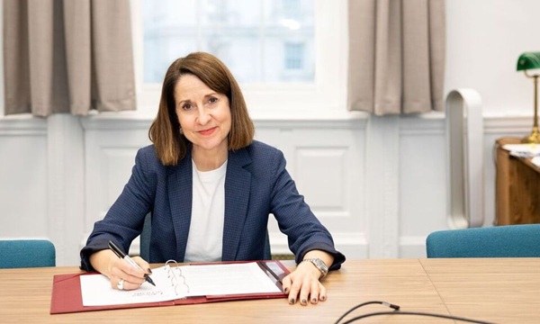 Technology Secretary Liz Kendall signs the government's new partnership with Google DeepMind